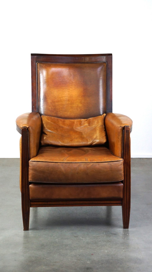 Sheep leather Art Deco design armchair with high back and wood finish