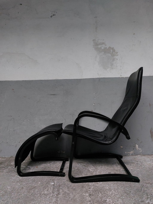 Black leather relax chair + Pouf, 1989