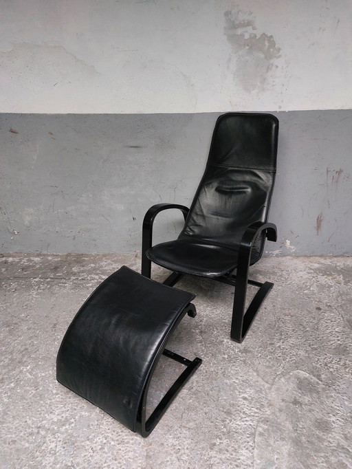 Black leather relax chair + Pouf, 1989