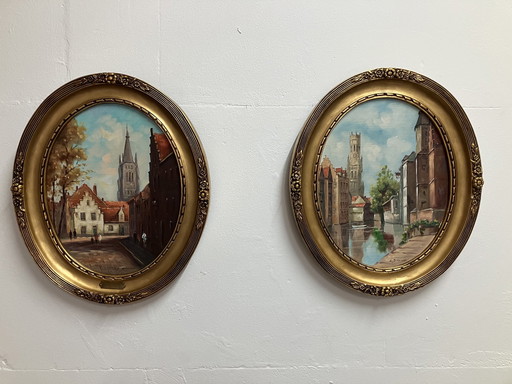 L. Douven Cityscapes, 2 Paintings In Oval Frames.