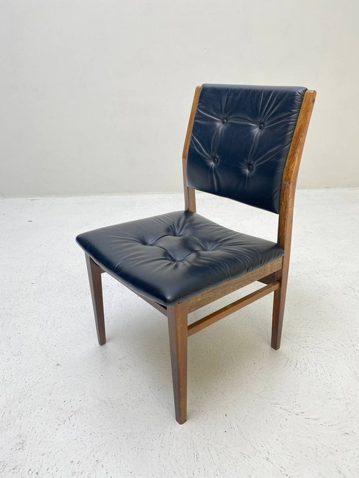 Elegant wooden chair with dark blue leather upholstery