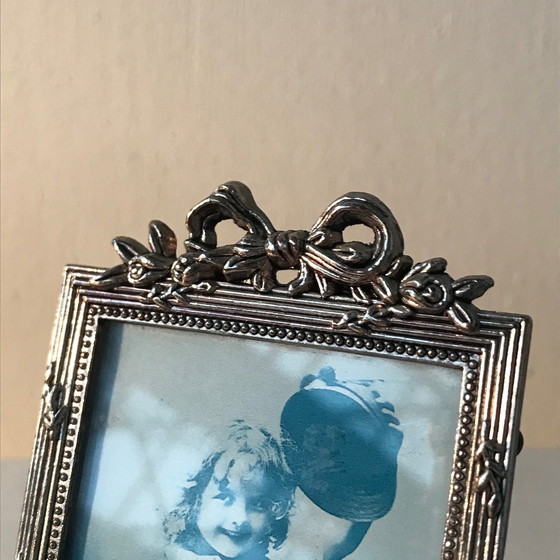 Image 1 of Cornice portafoto con fiocchi placcati in argento