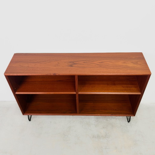 Open teak chest of drawers with steel feet