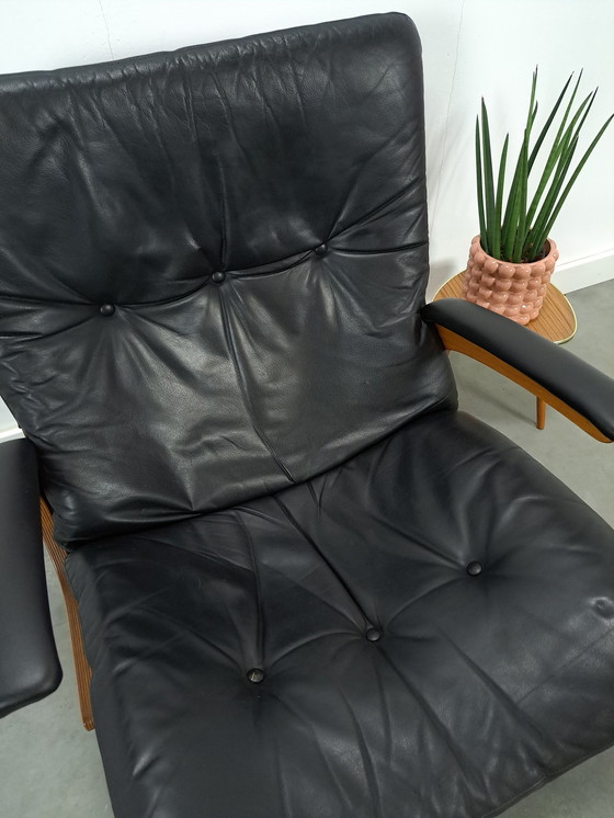 Image 1 of Black leather armchair with armrests and wooden base