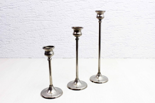 Trio of silver metal candlesticks from the 1950s