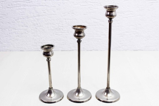 Trio of silver metal candlesticks from the 1950s