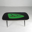 Vintage coffee table with glass top and angled, tapered legs. 1950s