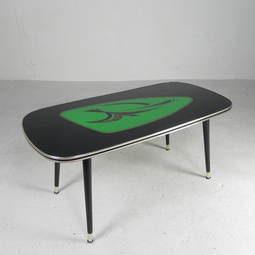 Vintage coffee table with glass top and angled, tapered legs. 1950s