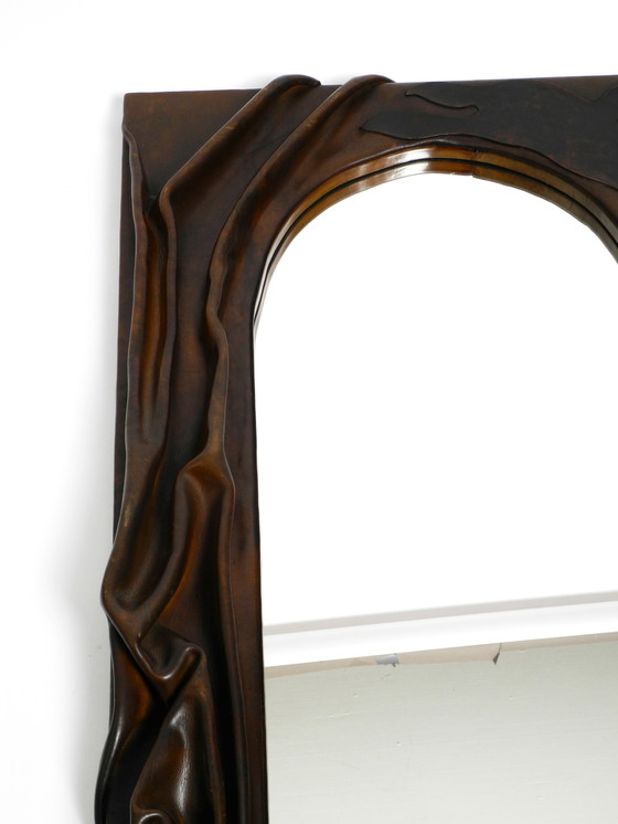 Image 1 of Large wooden wall mirror with an elaborate and thick flowing leather cover from the 1970s