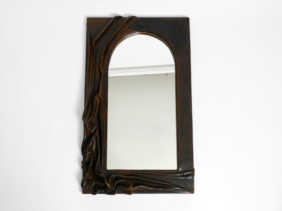 Image 1 of Large wooden wall mirror with an elaborate and thick flowing leather cover from the 1970s