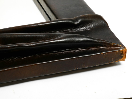 Image 1 of Large wooden wall mirror with an elaborate and thick flowing leather cover from the 1970s