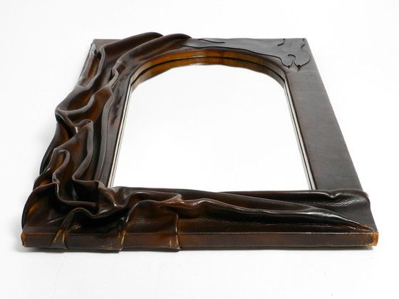 Image 1 of Large wooden wall mirror with an elaborate and thick flowing leather cover from the 1970s