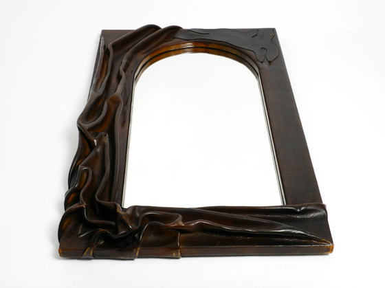 Image 1 of Large wooden wall mirror with an elaborate and thick flowing leather cover from the 1970s