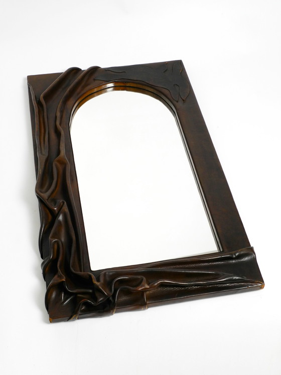 Image 1 of Large wooden wall mirror with an elaborate and thick flowing leather cover from the 1970s