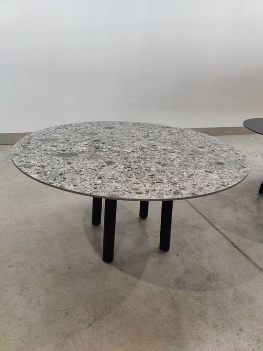 Round dining table with gray ceramic top