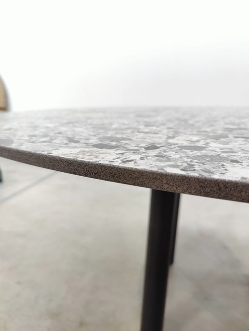 Round dining table with gray ceramic top