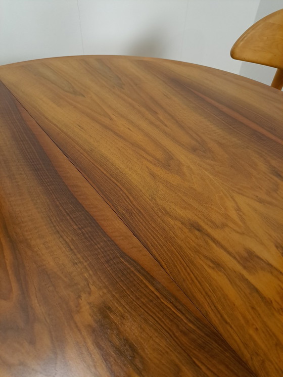 Image 1 of Large round walnut extendable dining table