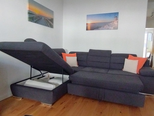 Corner sofa with bed function and bed base