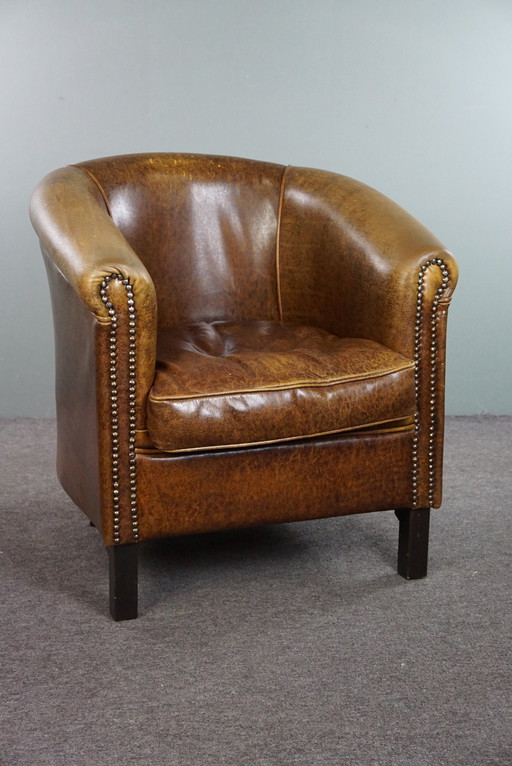 Leather club chair with decorative studs