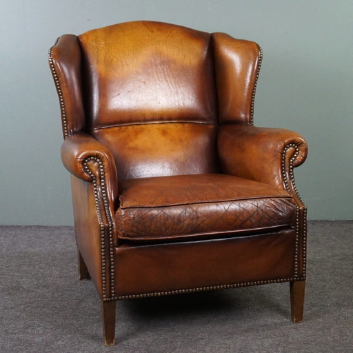 Sheep leather wing armchair with patina