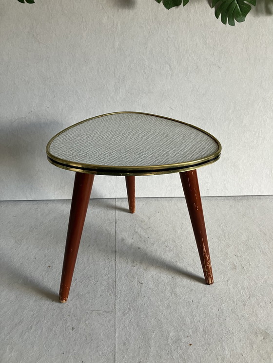 Image 1 of A Nice Vintage Plant Table From The 50s And 60s With Formica Top. Around the top is a strip in brass and black color.