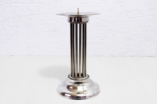 Modern candle holder in silver metal