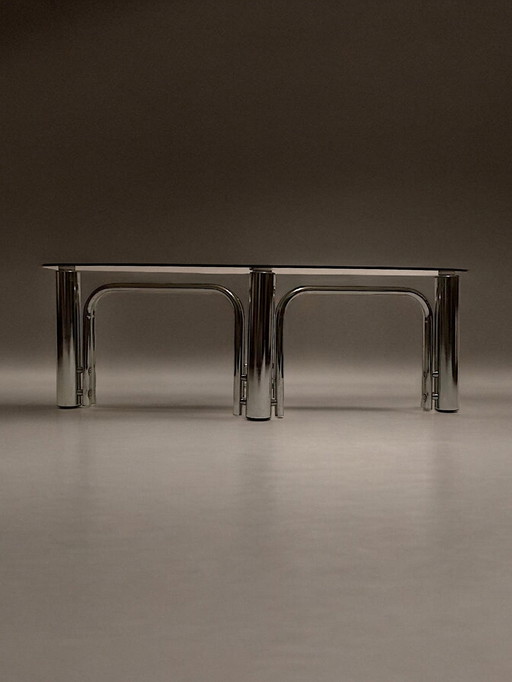 C. 1970 - Table Basse En Chrome Et Plateau En Verre Fumé De Forme Ovoïde - (Chrome and Smoked Glass Oval Coffee Table)