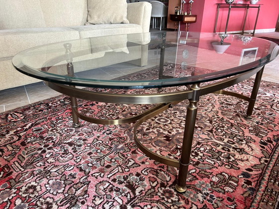 Image 1 of Glass oval coffee table with brass legs