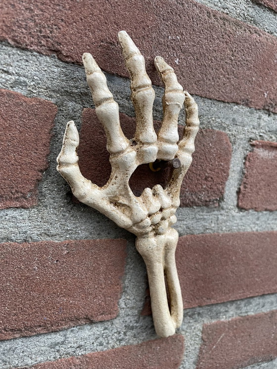 Image 1 of Set Of Two Cast Iron Bottle Openers Shaped Like Skeleton Hands