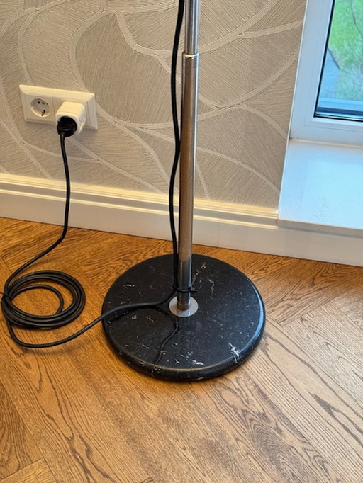 Mezzeluna halogen floor lamp on marble floor plate