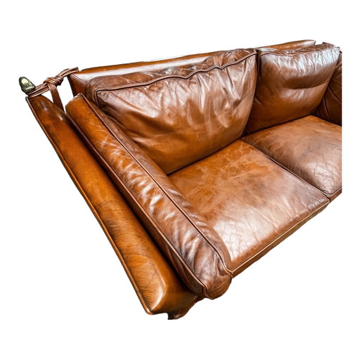 Comfortable sofa made of genuine leather with signs of wear