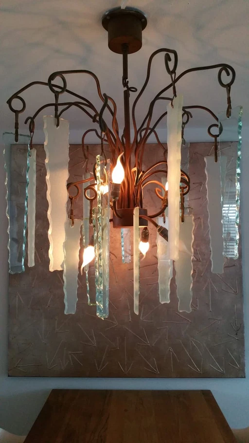 Brand and van Egmond chandelier behind the frosted glass