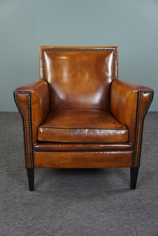 Art Deco armchair with black piping and decorative nails