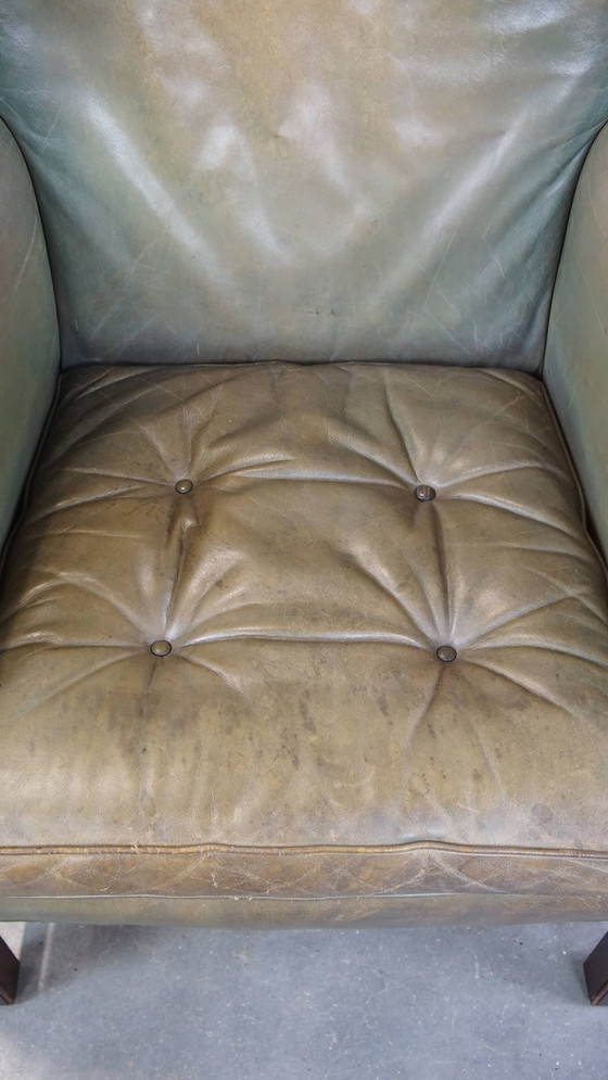 Image 1 of Sillón orejero de piel de vaca verde