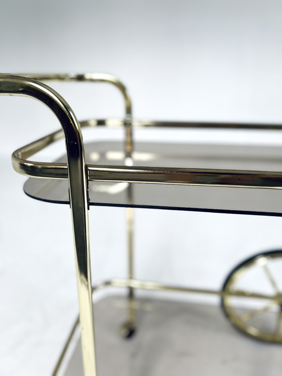 Image 1 of Smoked glass & brass coated bar cart