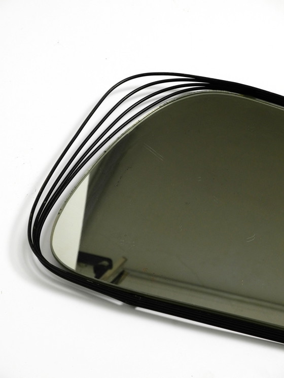 Image 1 of Mid Century Modern wall mirror with a black abstract metal frame