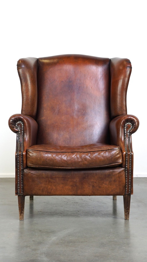 Grand fauteuil à oreilles en cuir de mouton