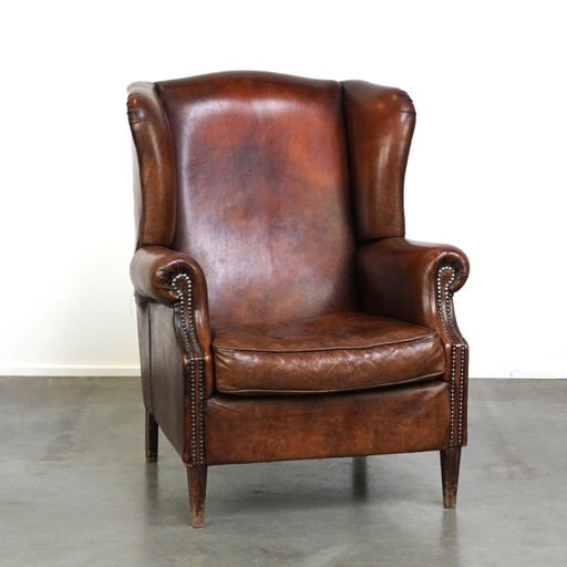 Grand fauteuil à oreilles en cuir de mouton