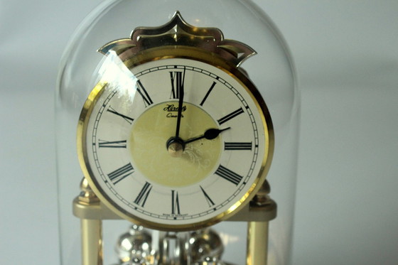 Image 1 of Elegant pendulum clock Hermle brass with glass dome, table clock, vintage