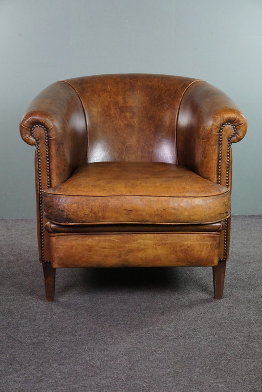 Club chair with patina, made of sheep leather