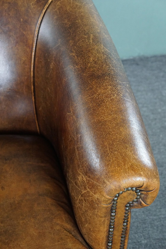 Image 1 of Club chair with patina, made of sheep leather