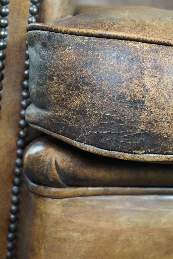 Image 1 of Club chair with patina, made of sheep leather