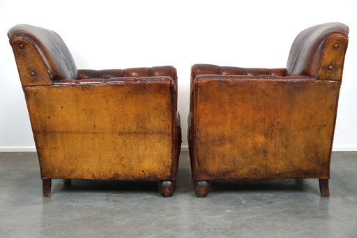 Set of 2 old sheep leather armchairs