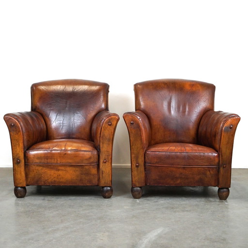 Set of 2 old sheep leather armchairs