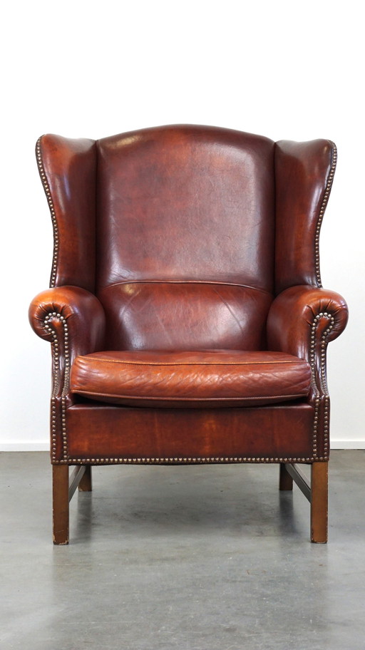 Grand fauteuil à oreilles en cuir de mouton