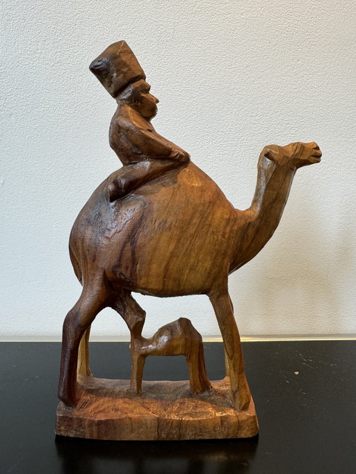 Wooden sculpture man on camel