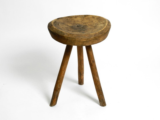 Image 1 of Beautiful 1900s hand-carved three-legged solid wood stool with a fantastic patina