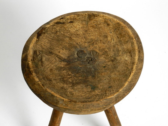 Image 1 of Beautiful 1900s hand-carved three-legged solid wood stool with a fantastic patina