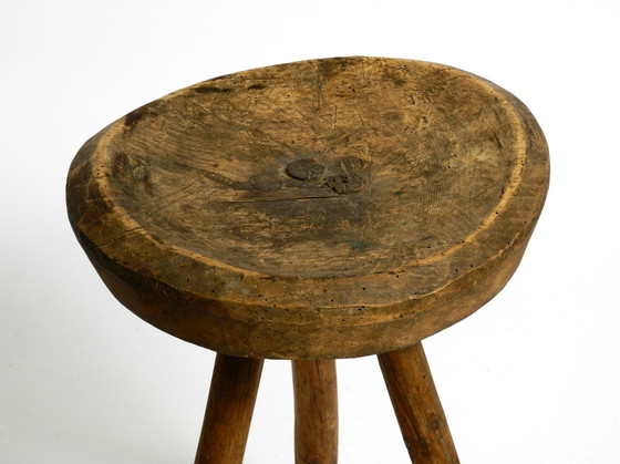 Image 1 of Beautiful 1900s hand-carved three-legged solid wood stool with a fantastic patina