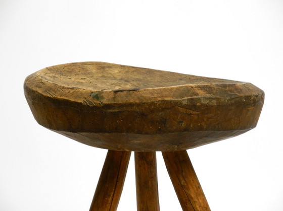 Image 1 of Beautiful 1900s hand-carved three-legged solid wood stool with a fantastic patina